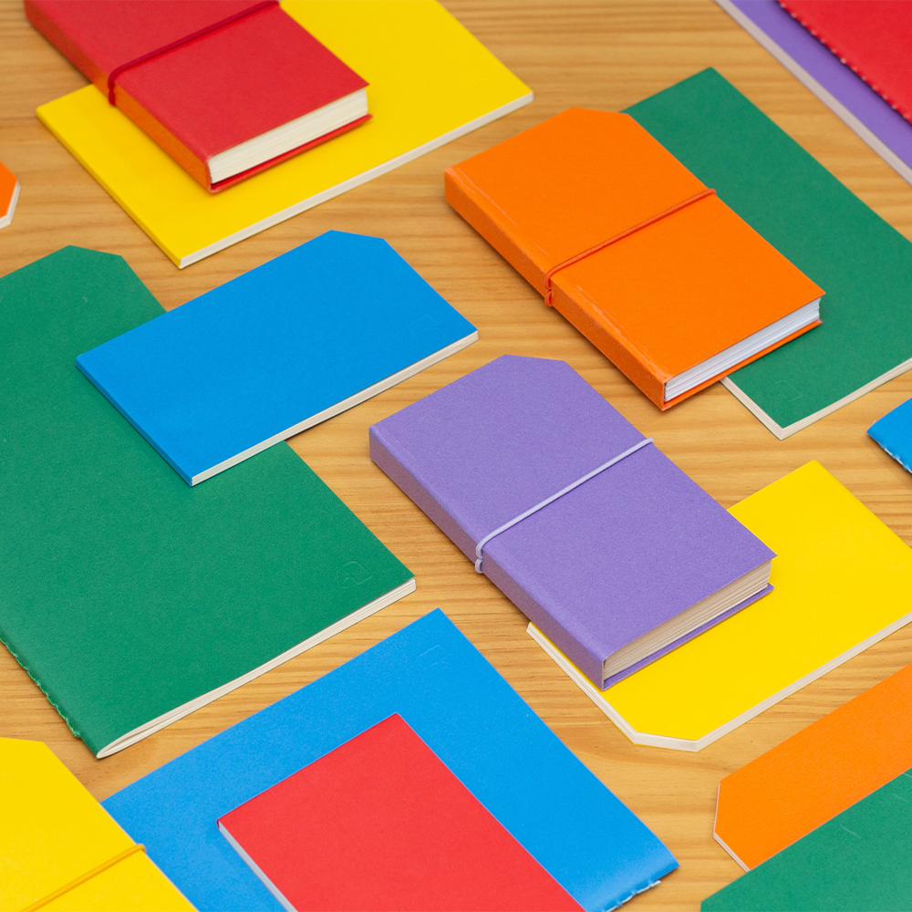 Colourful notebooks laying on a table.