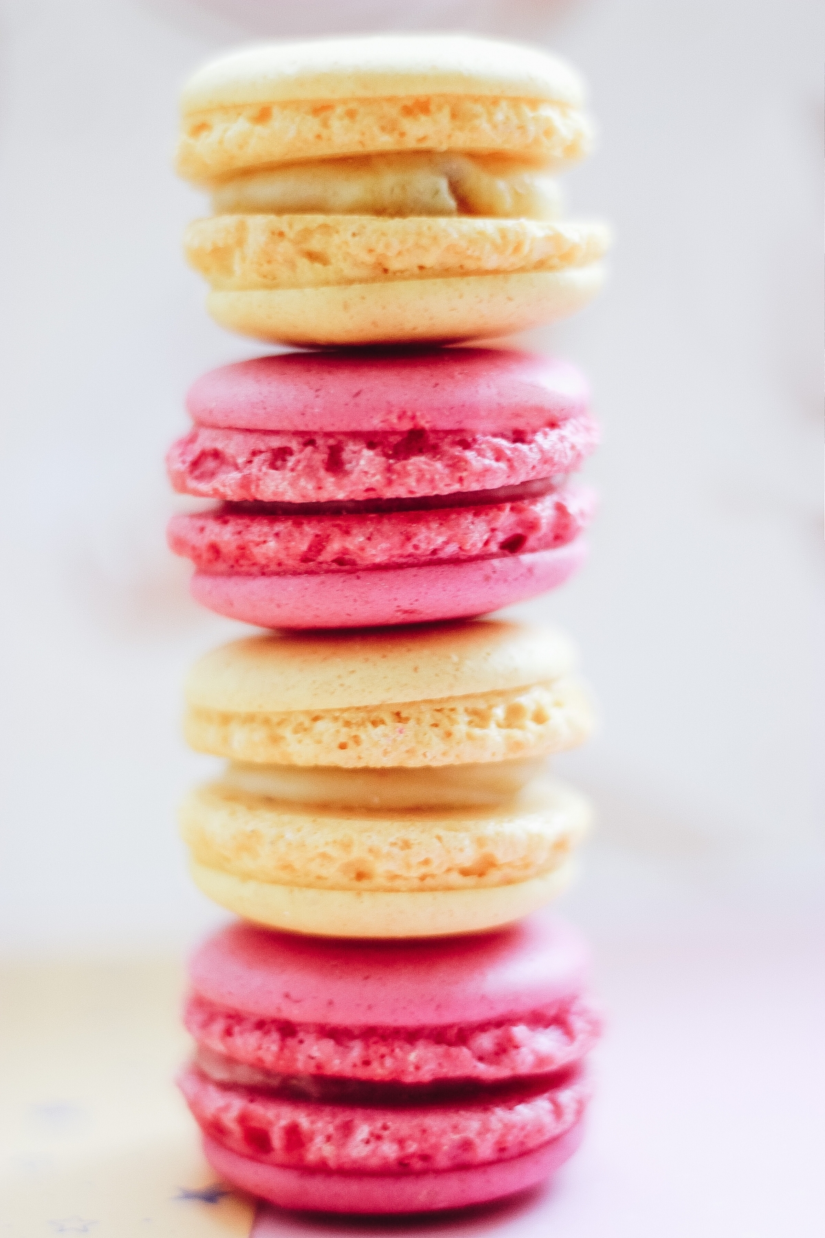 Stack of pink and yellow macarons