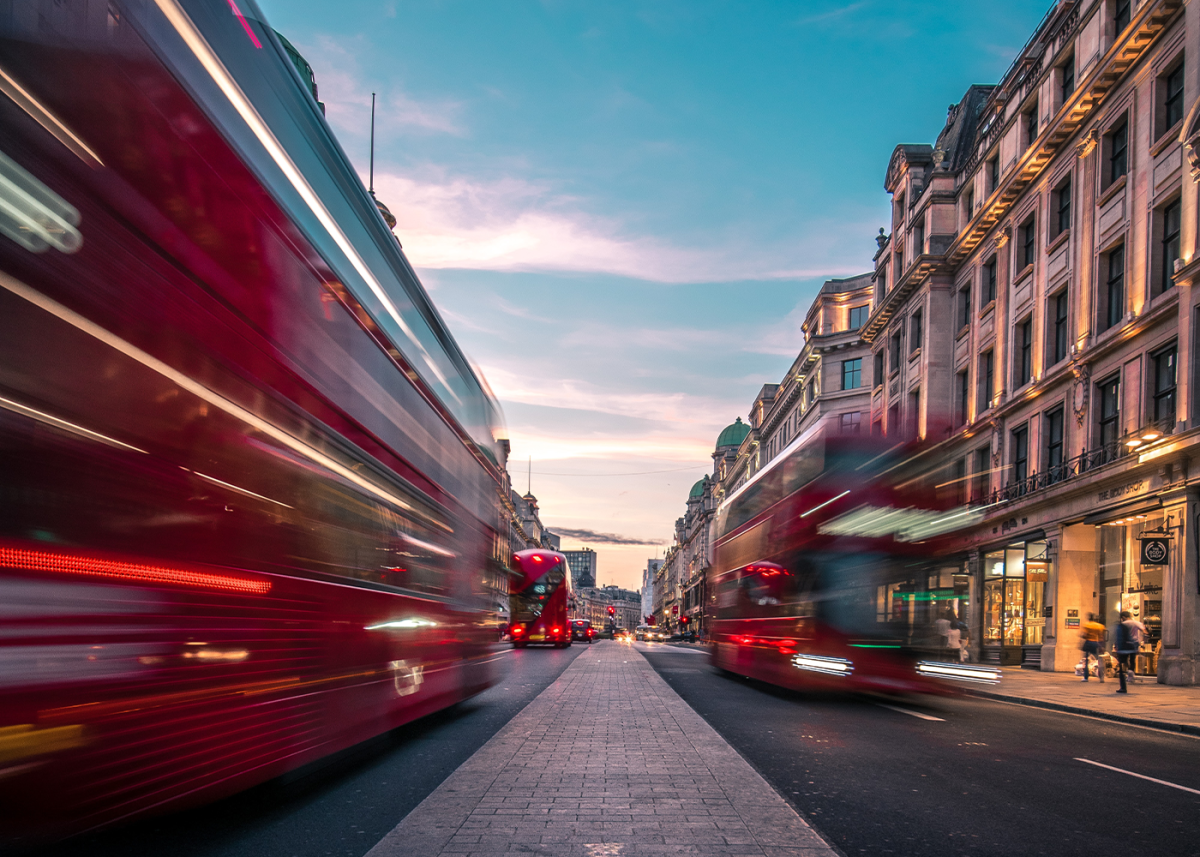 London buses moving down the street.