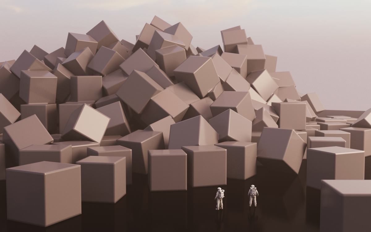 Astronaut exploring landscape with large blocks