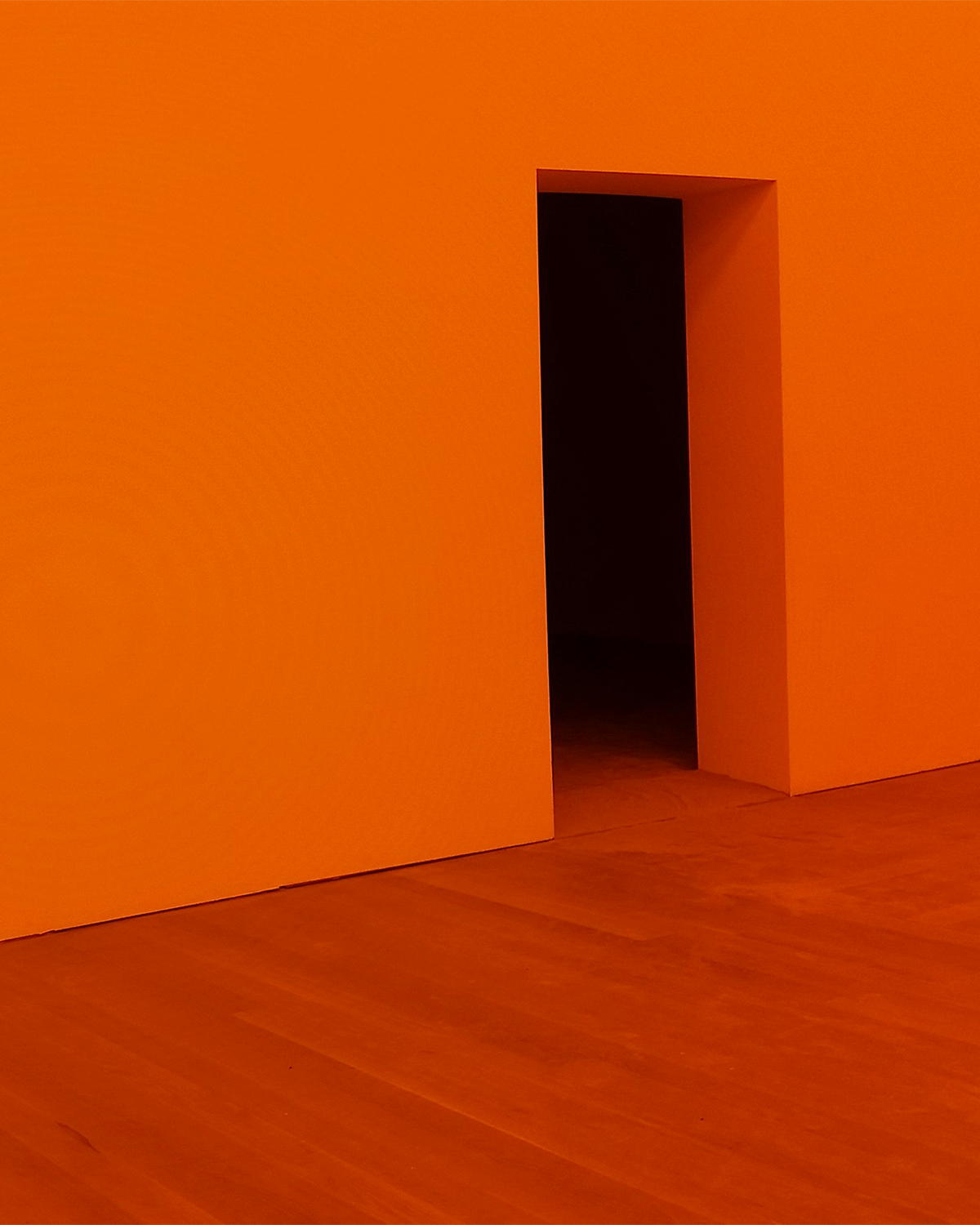 Doorway in a orange painted room.
