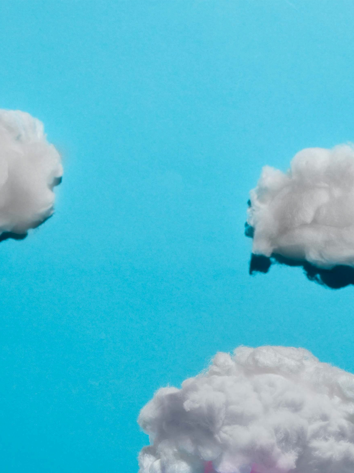 White clouds against a blue background.