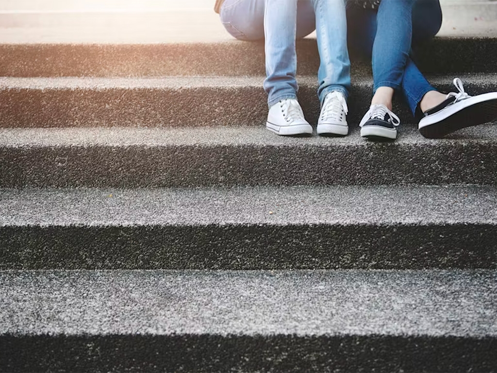 Two friends sitting on stairs