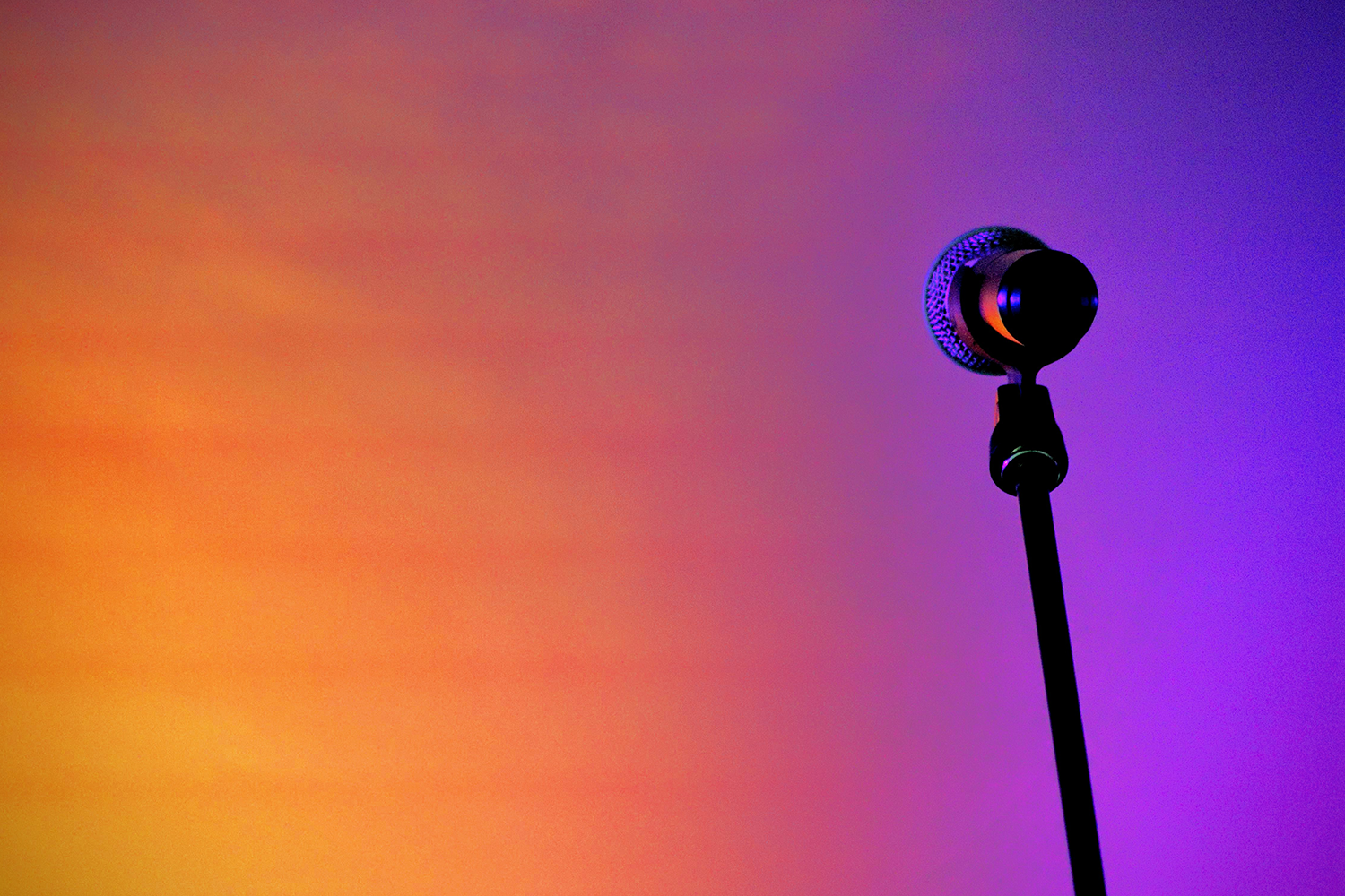 Microphone against an orange and purple background.