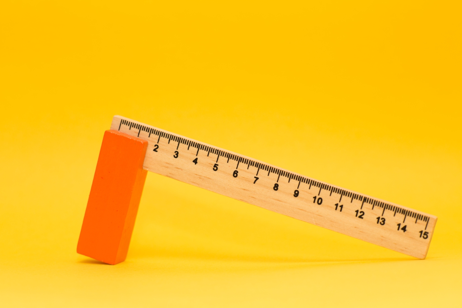 Ruler propped up against a yellow background.