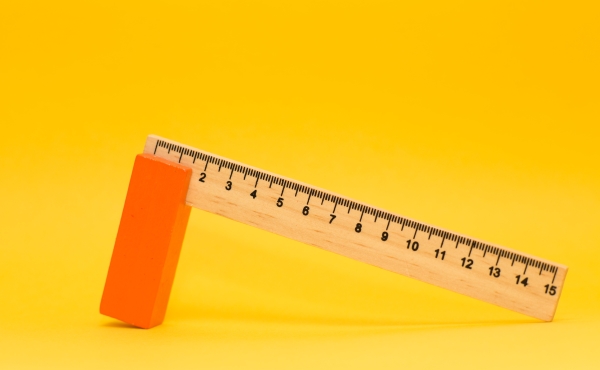 Ruler propped up against a yellow background.