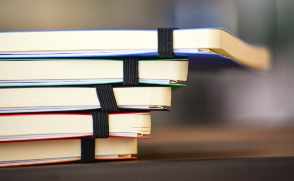 Notebooks stacked on top of one another.