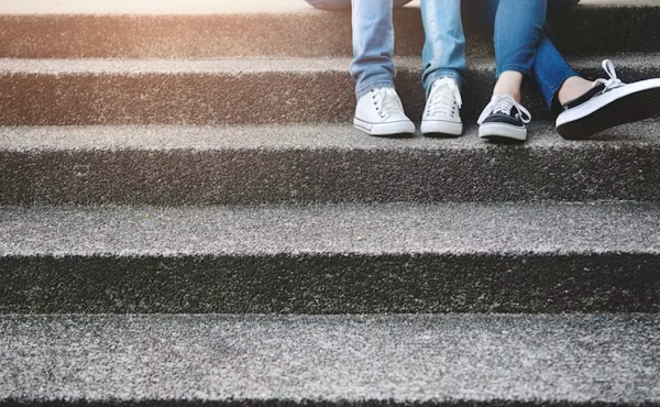 Two friends sitting on stairs