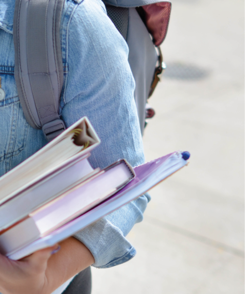 A student carrying books.
