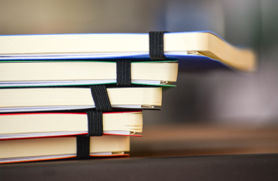 Notebooks stacked on top of one another.