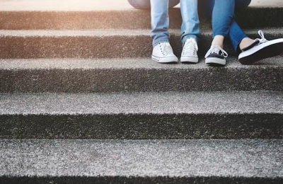 Two friends sitting on stairs
