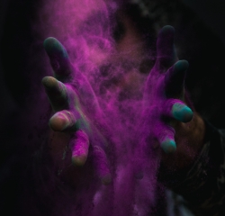 Purple powder between a pair of hands